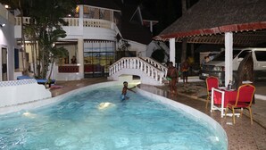 A swimming pool area with a water slide, lounge chairs, and a covered seating area. - Room in Guest Room - A Wonderful Beach Property in Diani Beach Kenya - a Dream Holiday Place (Mombasa)