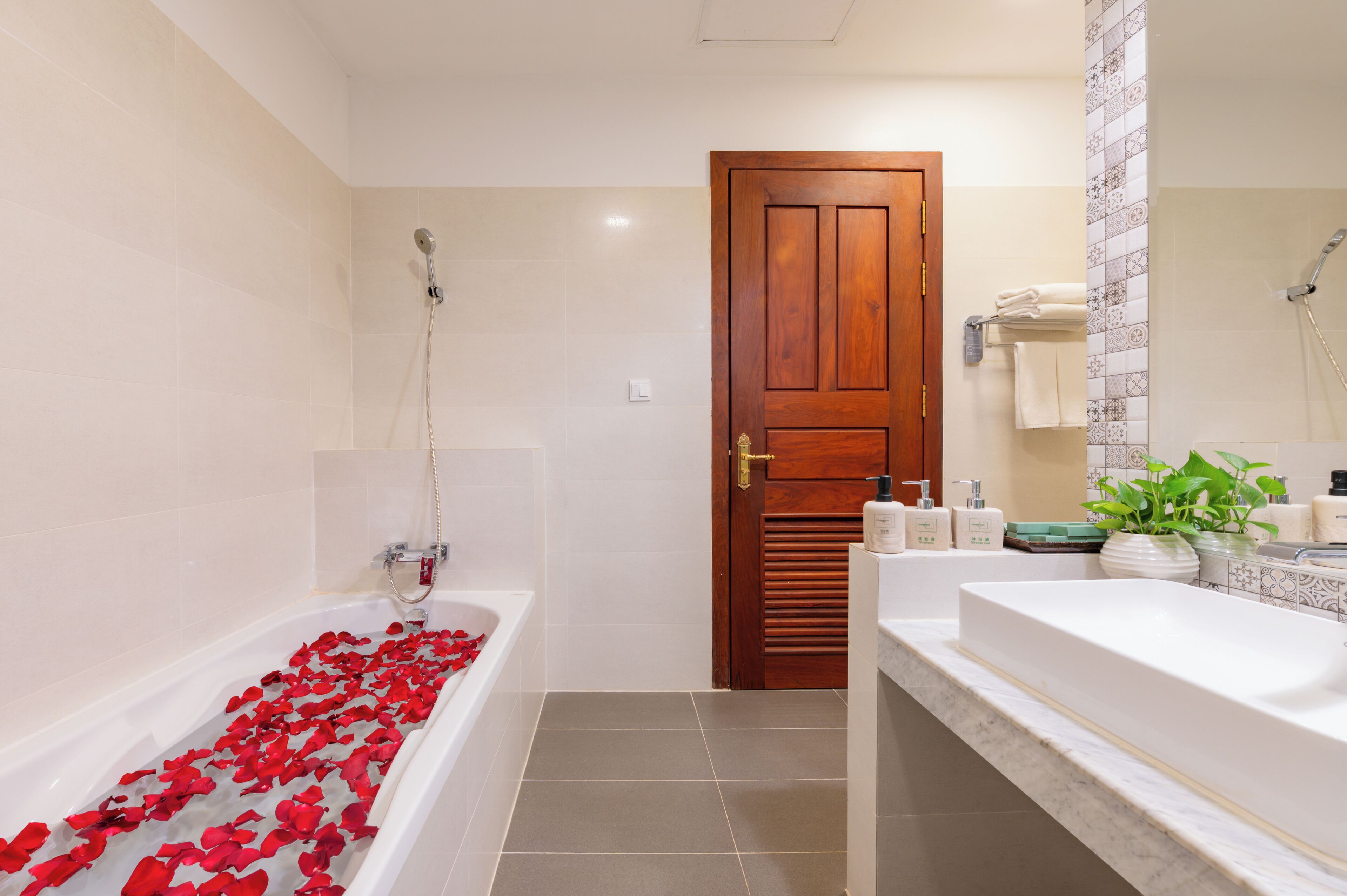 A bathroom with a bathtub, shower, and sink.