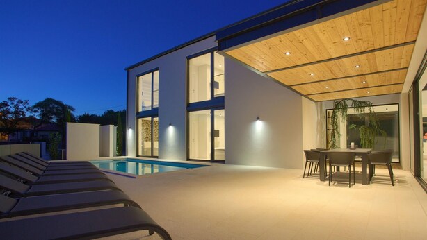 A modern house with a swimming pool, outdoor seating, and large windows. - Casa Bela with heated pool and luxury of 5 stars (Klimno (Krk))