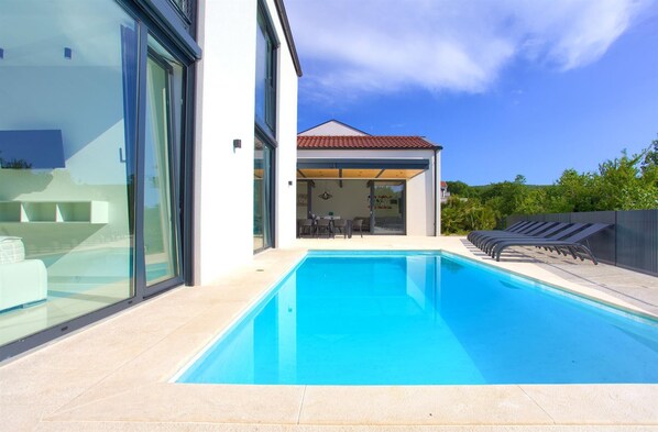 A heated pool, pool loungers