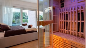 A bedroom with a large window, a bed, and a wooden deck area with a railing. - Villa Zarra with heated pool, jacuzzi, sauna and Seaview (Klimno (Krk))