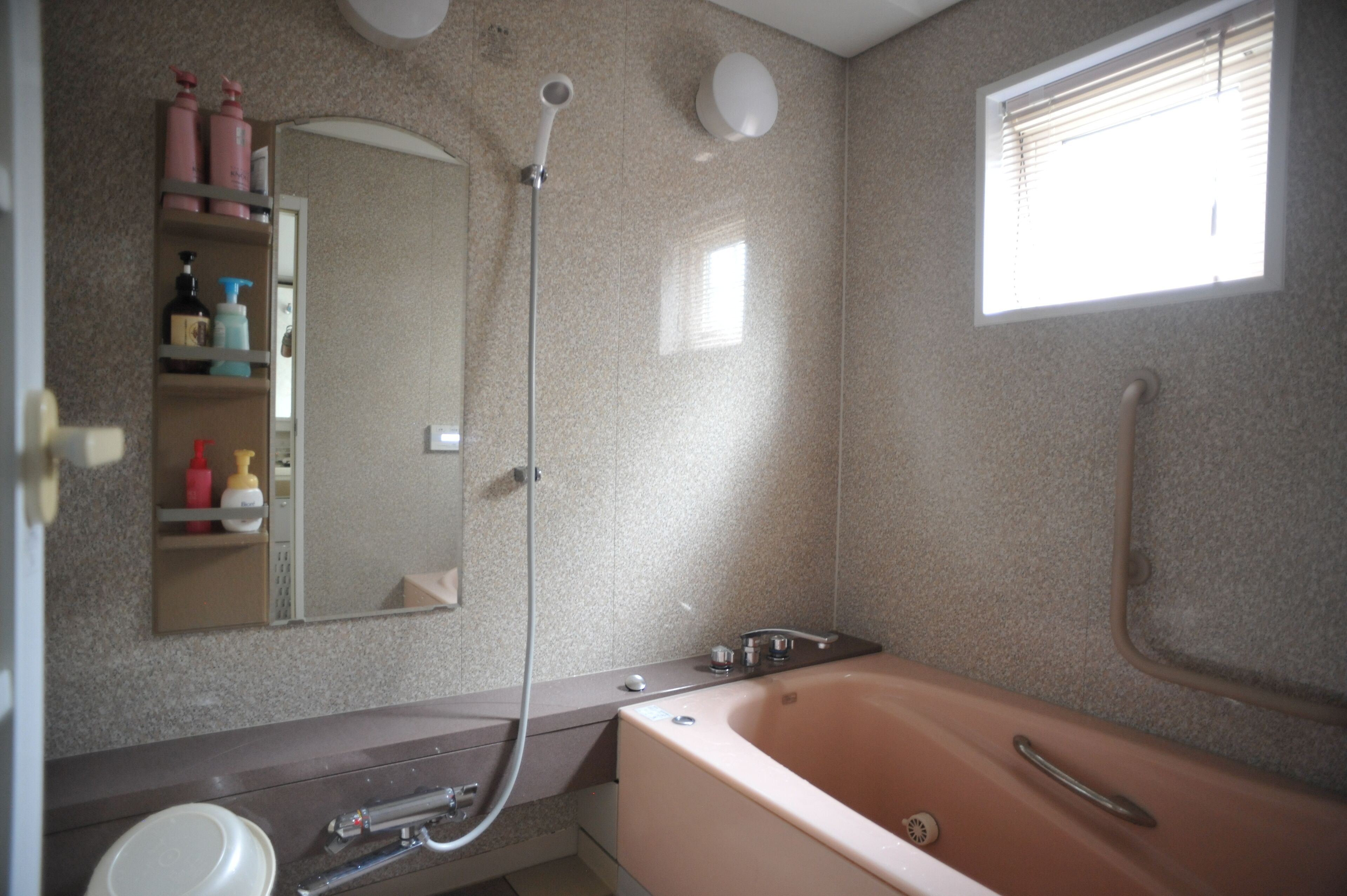 A bathroom with a bathtub, a shower, a sink, and a mirror.