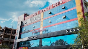A multi-story building with a 'Five Town Club' sign, a 'Hotel Opera Inn', and a 'Nexa' sign. - Hotel Opera Inn near Central Bus Stand (Udaipur)