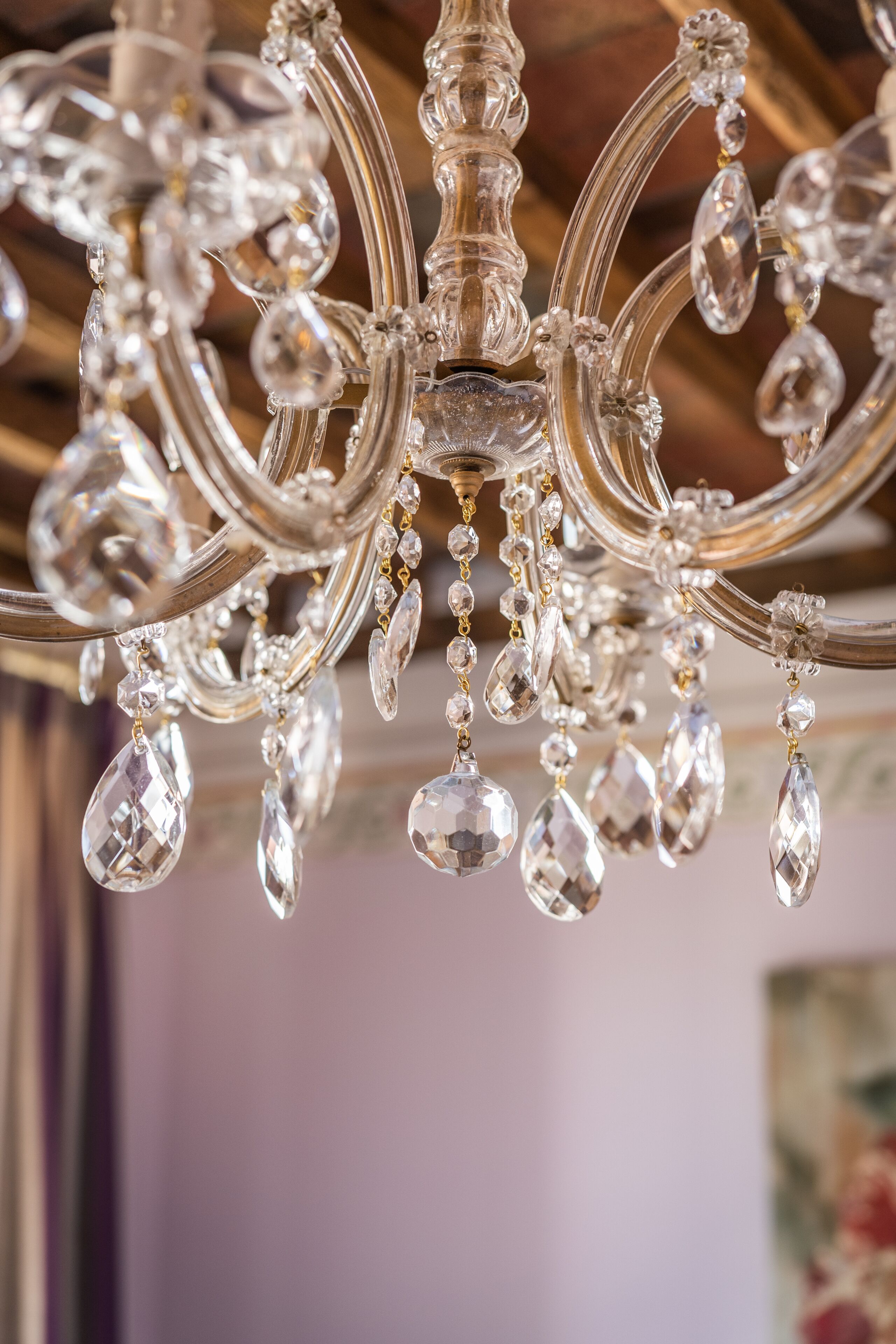 A chandelier with multiple arms and hanging crystal elements.