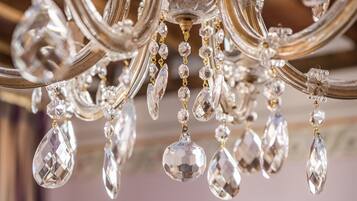 A chandelier with multiple arms and hanging crystal elements.