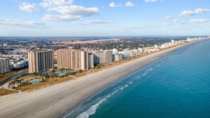 A coastal cityscape with a long beachfront, high-rise hotels, and a clear sky. - 2/2 Townhome North Beach Resort- Pools, Hot tubs, (North Myrtle Beach)