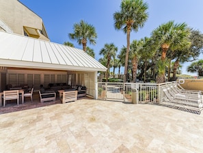 An outdoor patio area with seating arrangements and a covered section.