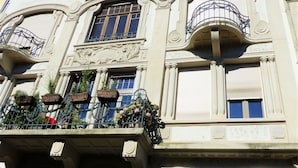 A multi-story building with ornate balconies, large windows, and a sign indicating the address. - quai koch 90m2 city center    3br (Strasbourg)
