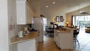 Enjoy meals in the kitchen with a central island and dining area offering a view of the outdoors.