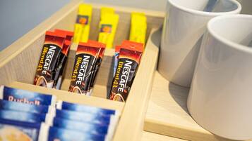 A tray with Nescafé Blend 43 coffee packets and a cup of coffee.