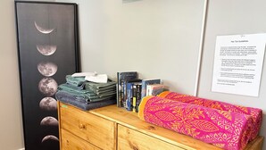 A wooden dresser with folded towels, a stack of books, and a framed poster of the moon phases. - Upstairs, downtown Boise, private, close to green belt and Boise State. (Boise)