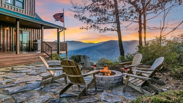 A wooden deck with Adirondack chairs, a fire pit, and an American flag. - Magnificent Mountain Views (Sapphire)