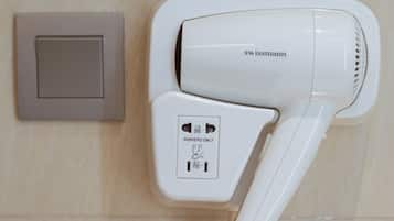 A hair dryer mounted on a wall with a control panel and a power outlet.