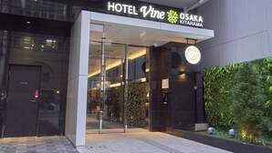 The entrance to HOTEL Vine in OSAKA KITAHAMA, featuring a modern glass facade, a private entrance door, and a logo for BROWN COFFEE STUDIO. - Hotel Vine Osaka Kitahama (Osaka)