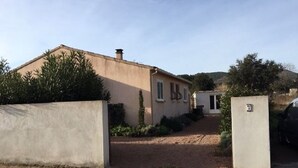 A building with a paved driveway leading to a gated entrance.