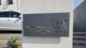 A sign on a textured wall with the name "The Ashcroft" in metallic letters. - The Ashcroft Apartments (Manchester)
