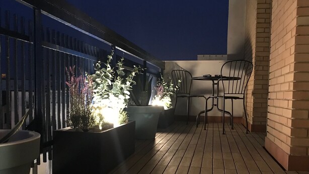 A rooftop terrace with wooden flooring, potted plants, and metal chairs. - Wonderful apartment in quiet residential complex. (Cattolica)