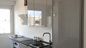 A modern kitchen with a stainless steel refrigerator, double sink, and built-in oven. - Wonderful apartment in quiet residential complex. (Cattolica)
