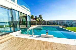 Outdoor pool, open 9:00 AM to 7:00 PM, pool umbrellas, pool loungers