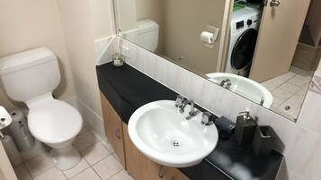 Bathtub, towels, soap, toilet paper