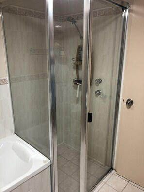 Bathtub, towels, soap, toilet paper