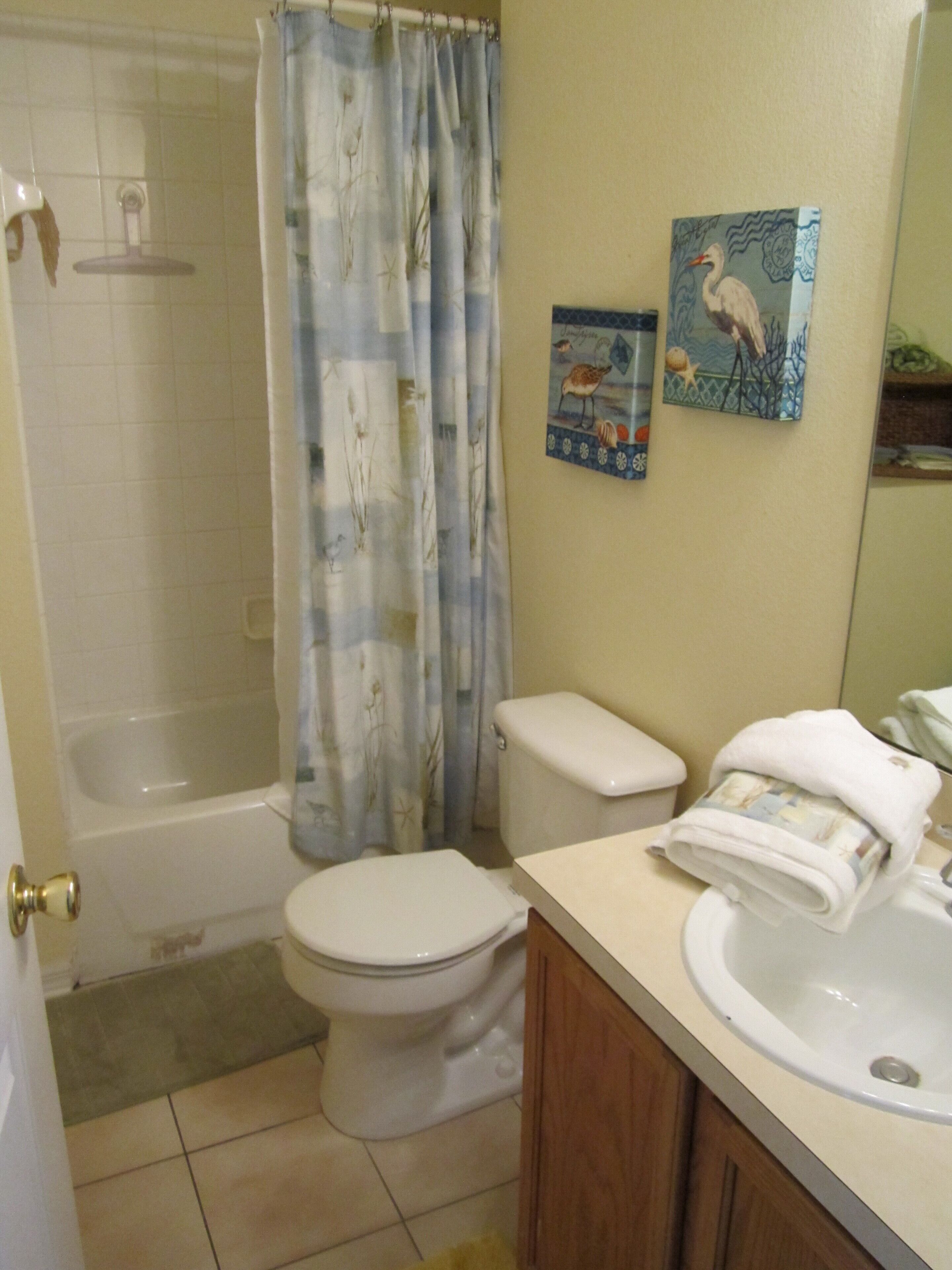A bathroom with a bathtub, toilet, and sink.