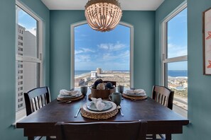 A dining room with a view of the city and ocean.