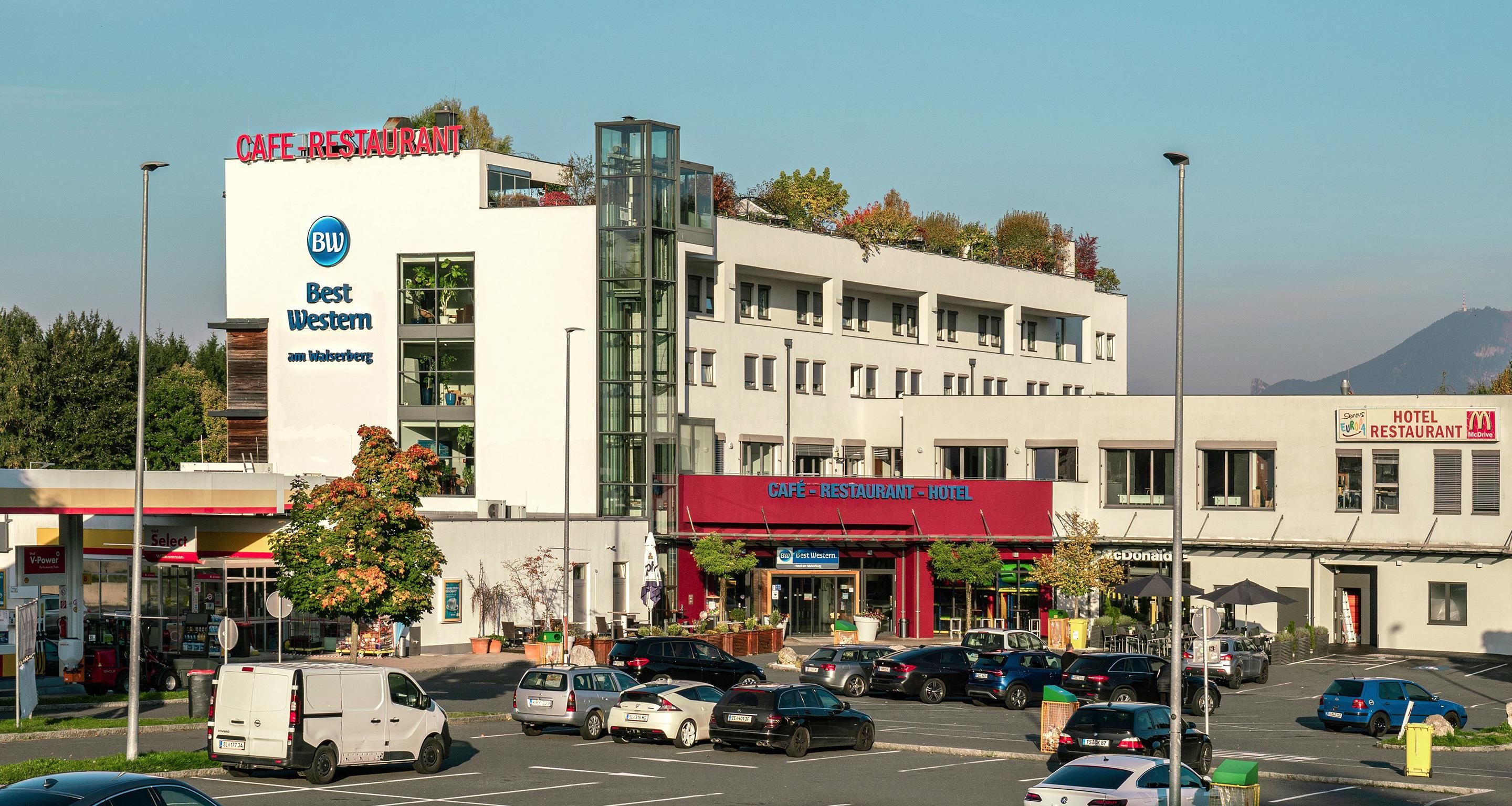 A multi-story building with signage for a cafe, restaurant, and hotel.