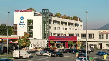 A multi-story building with signage for a cafe, restaurant, and hotel.
