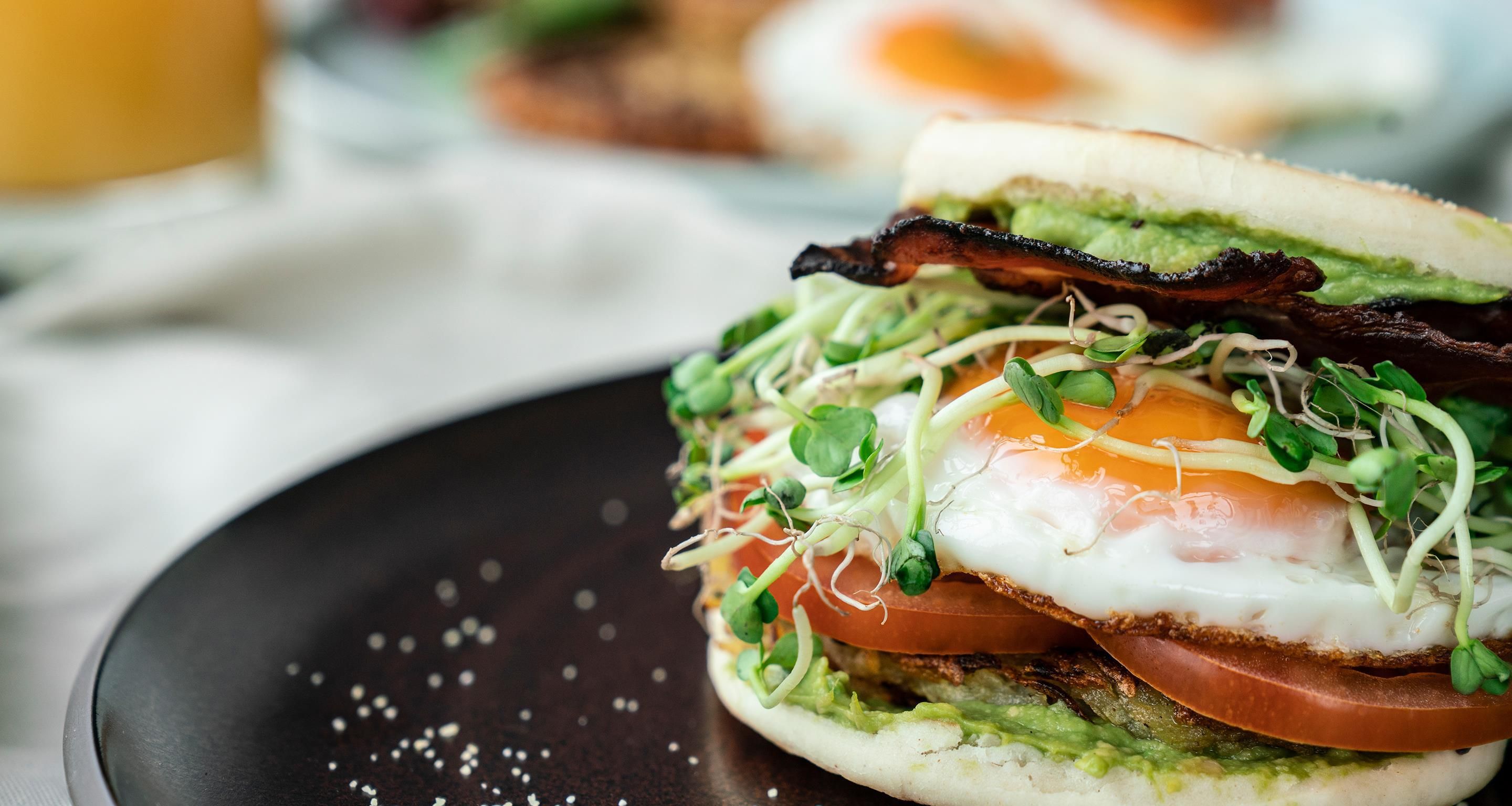 A sandwich with various ingredients on a plate.