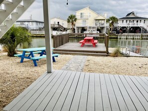 Enjoy waterfront views from the deck, where a picnic table awaits beneath a palm tree.