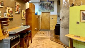 A restaurant with a wooden interior, a counter with stools, and artwork on the walls. - One of a kind cabin in the woods.  Quiet and private but close to everything.  (Coxs Creek)