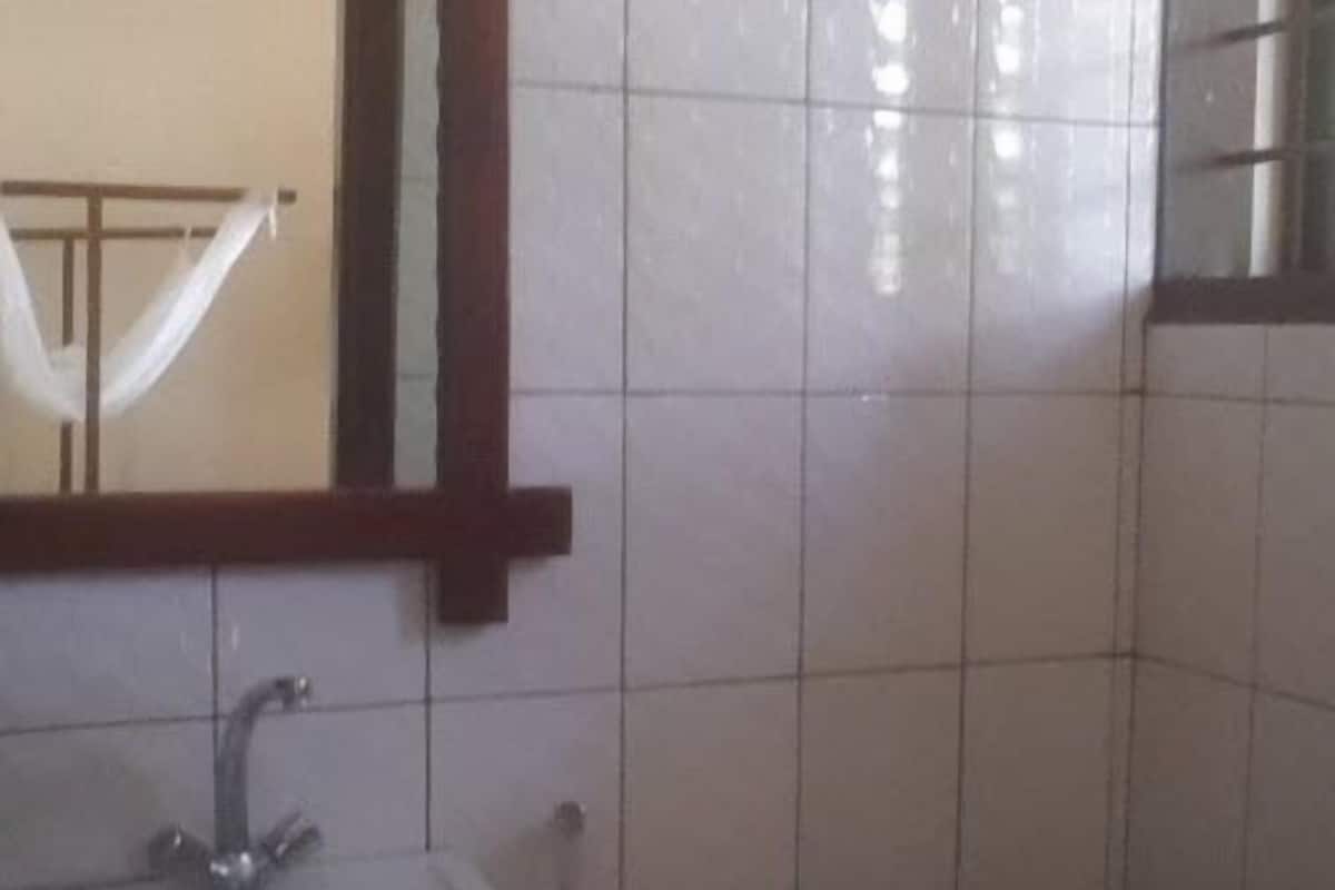 A bathroom with a sink, mirror, and toilet.