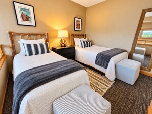 A hotel room with two beds, a nightstand with a lamp, a mirror, and a window with a view. - Ski-In/Ski-Out 1BR+Loft | Moose Mtn Views | Pool (Lutsen)