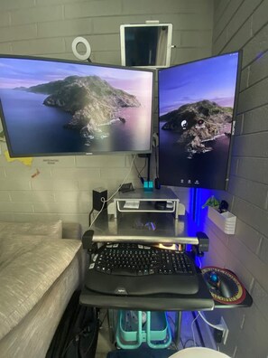 Work in comfort with a dedicated desk and ergonomic setup.