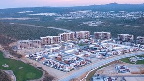 An aerial view of a residential area with multiple apartment buildings, roads, and green spaces. - CCV Quivira-Lux 2BR, Lg Patio w/Outdoor Kitchen, Ocean View, Golf! (Cabo San Lucas)