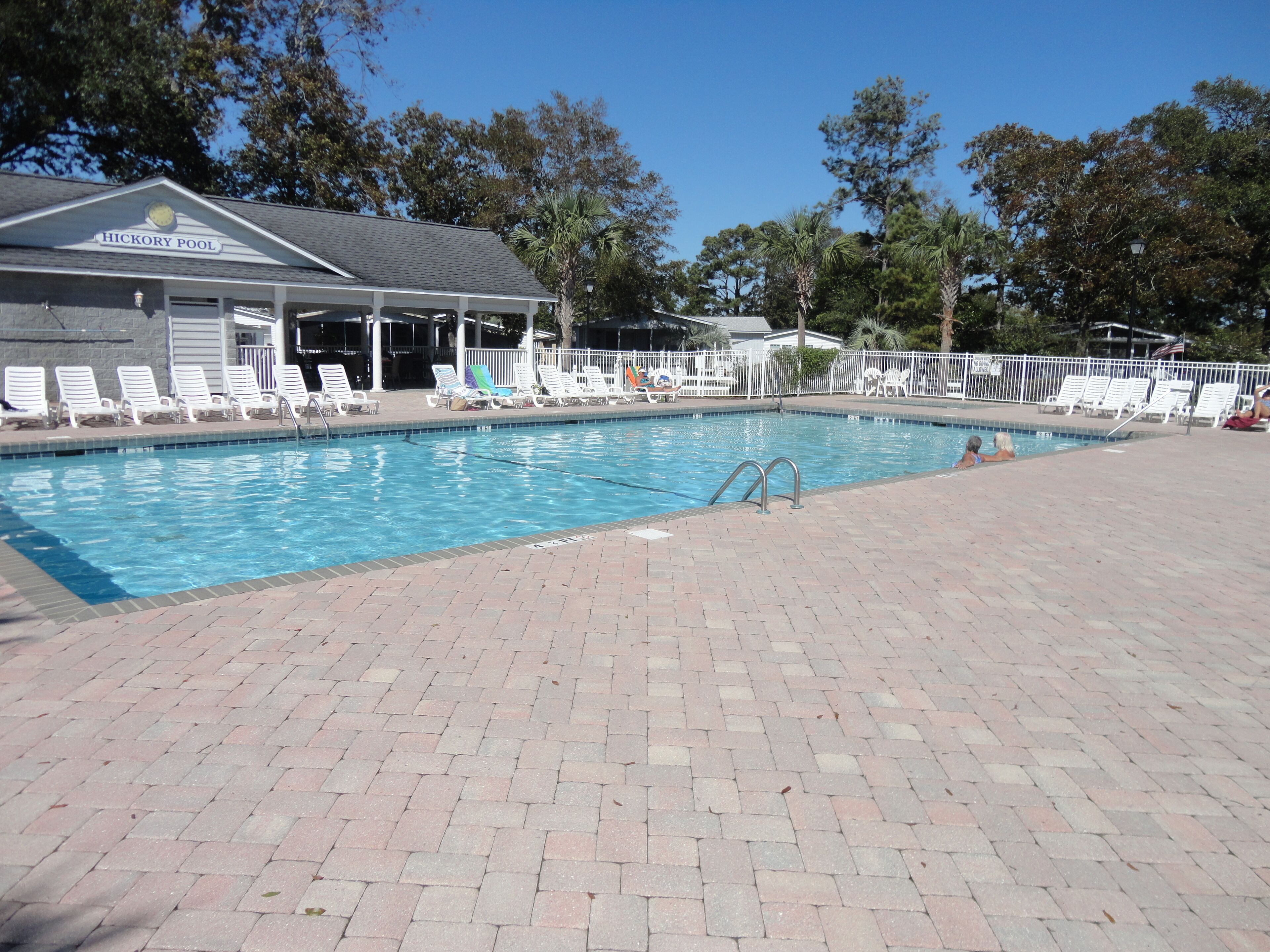 A swimming pool with lounge chairs and a covered area labeled "HICKORY POOL".