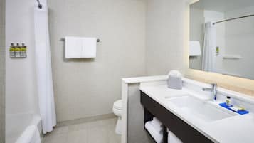 A modern bathroom with a shower, toilet, and sink.