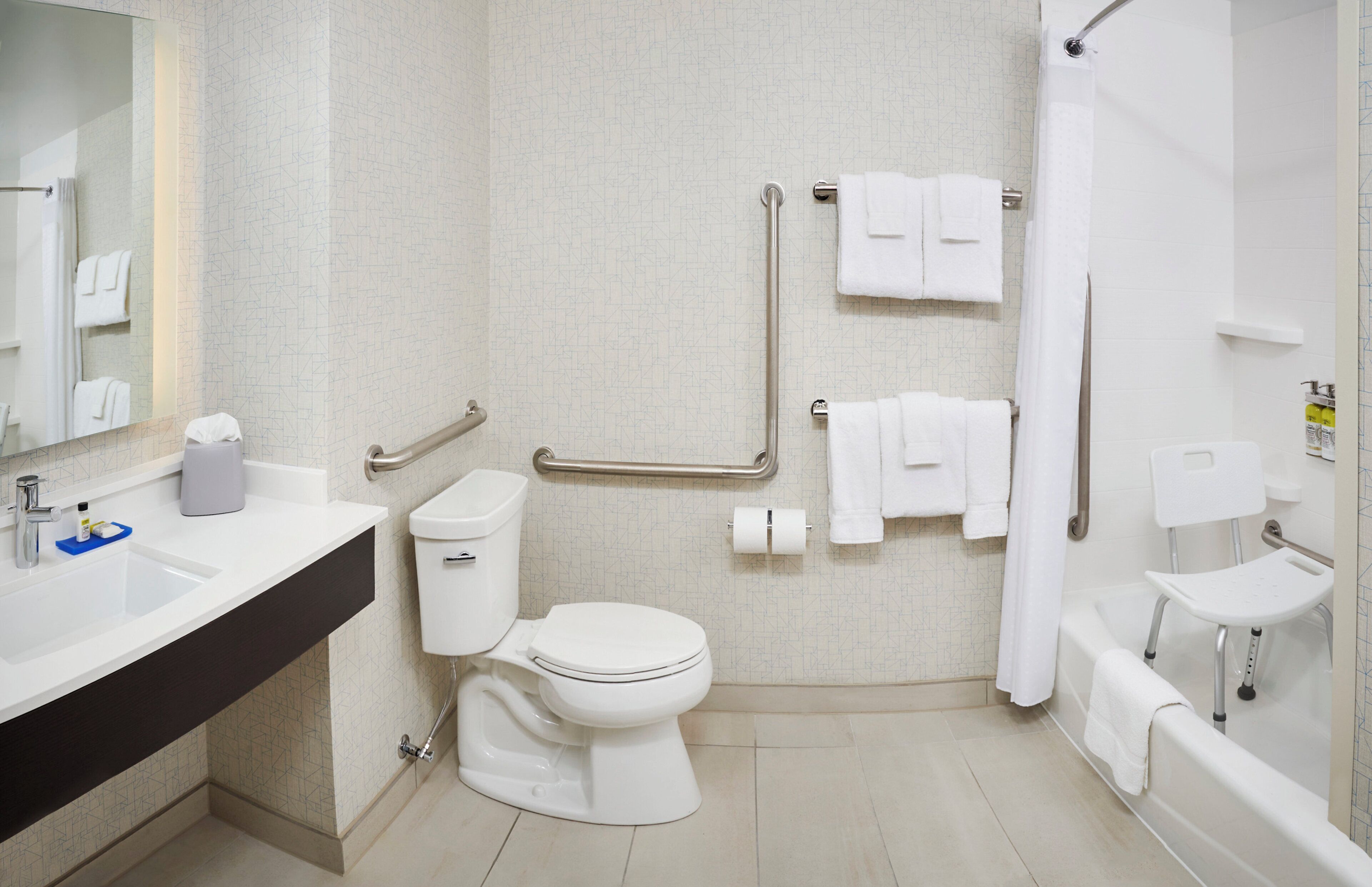 Un baño con inodoro, lavamanos y zona de ducha.