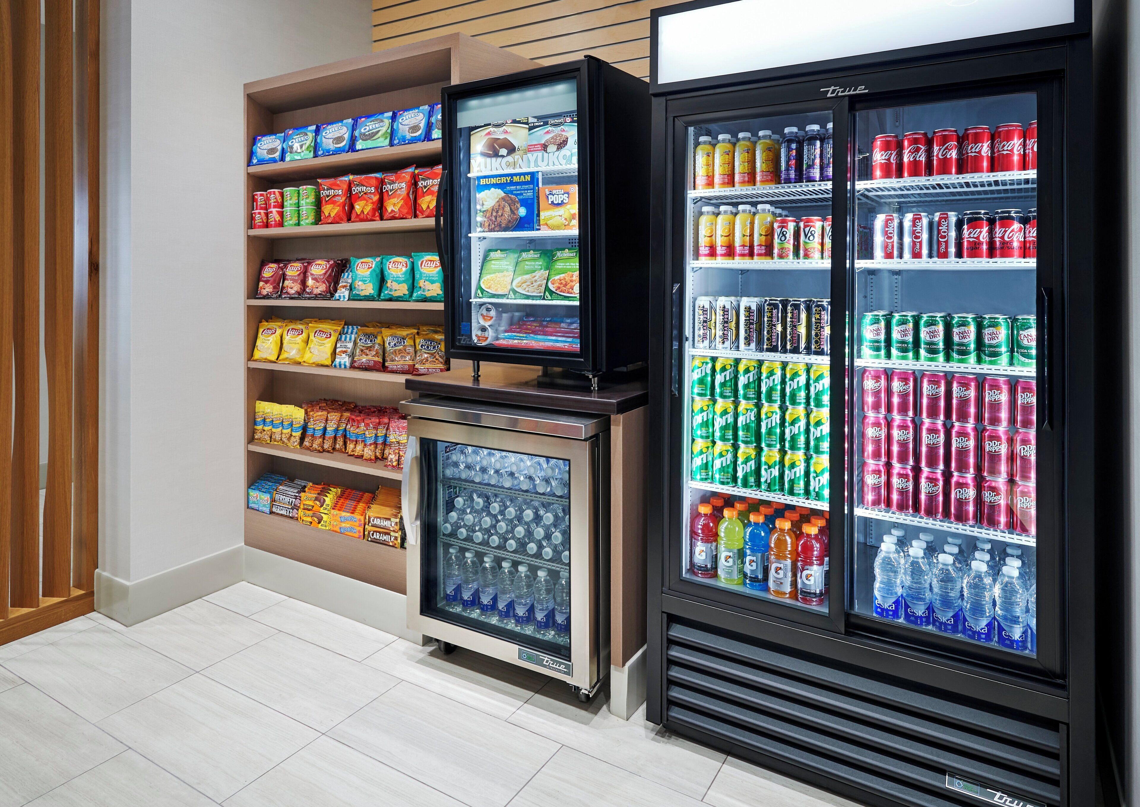 A refrigerated display case with various snacks and drinks.