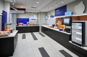 A modern breakfast area with a bakery section, yogurt and milk dispensers, and a clean, tiled floor. - Holiday Inn Express & Suites Windsor East - Lakeshore by IHG (Lakeshore)