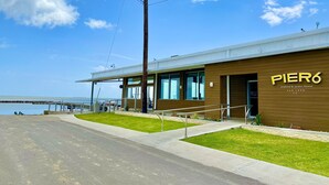 A modern building with a sign reading "PIER6 seafood & oyster house" in San Leon, TX.