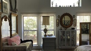 A bedroom with a large window, a dresser, a cabinet, and a bed. - Great Location close to everything (Texarkana)