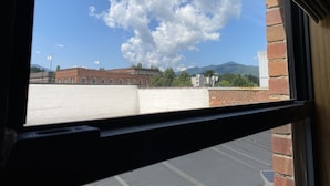 A view from a window with a brick wall and a clear sky. - Main Street Retreats 105 - Brand New Apt. 105 (Waynesville)