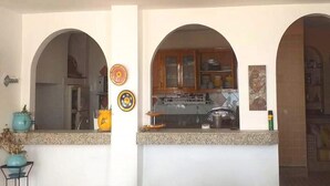 Una cocina con arcos, encimera de granito y armarios de madera.