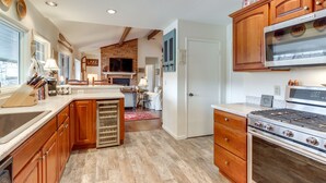 A modern kitchen with wooden cabinets, a built-in oven, and a large island. - Nantahala Lake Family Home w/ Private Dock & Views (Topton)