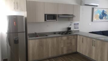 Fridge, microwave, coffee/tea maker, cookware/dishes/utensils