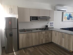 Refrigerador, microondas, cafetera y tetera y utensilios de cocina 