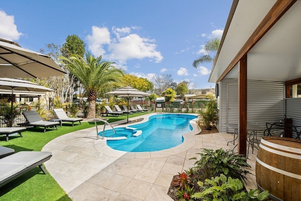 2 outdoor pools, a heated pool, open 10:00 AM to 6:00 PM, pool umbrellas