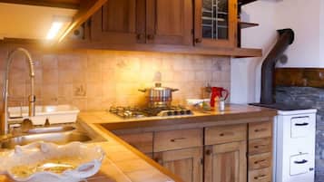 Fridge, high chair, cookware/dishes/utensils, dining tables